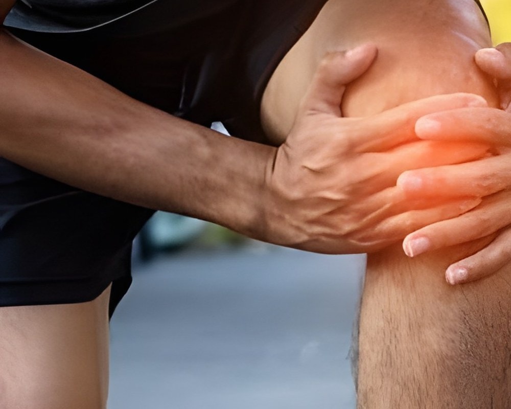 Person holding a painful knee